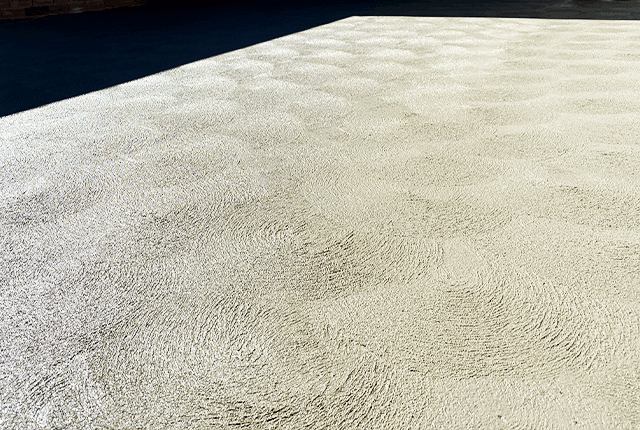 Newly paved concrete car park surface with textured finish.