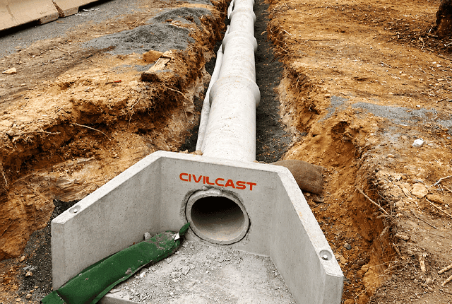 Concrete drainage pipe installed in trench for effective water management.