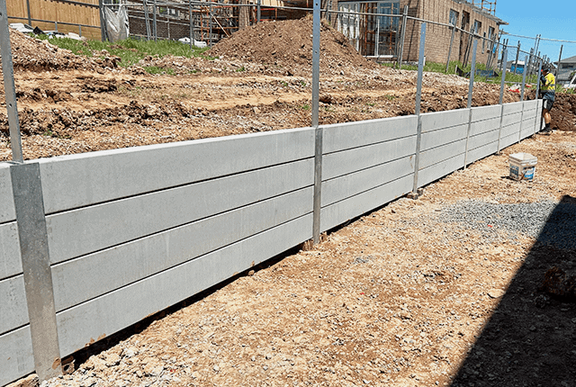 Concrete retaining wall built for landscaping and erosion control.