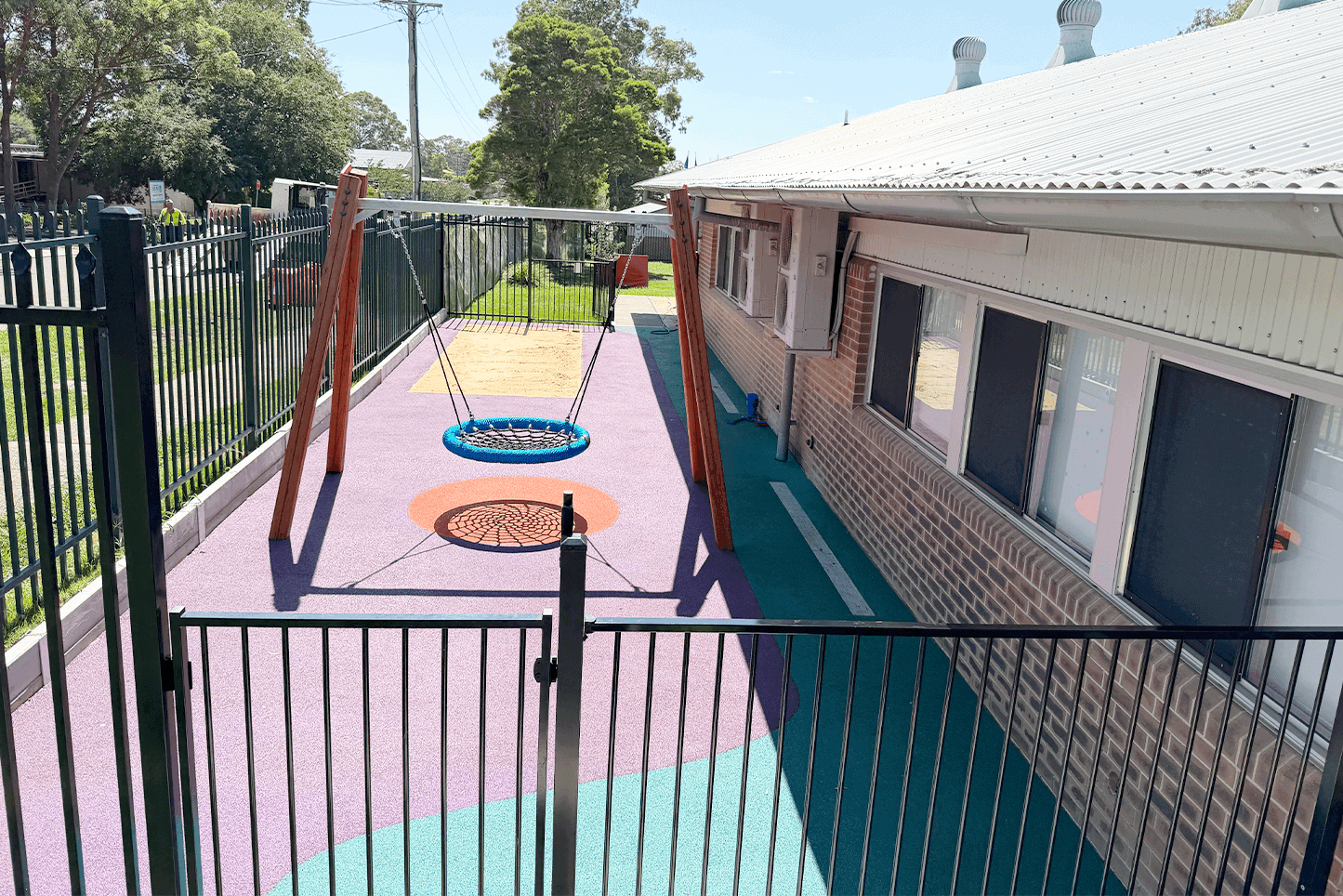 Colorful children's playground with swing and safety surface at Said Civil Contractors.