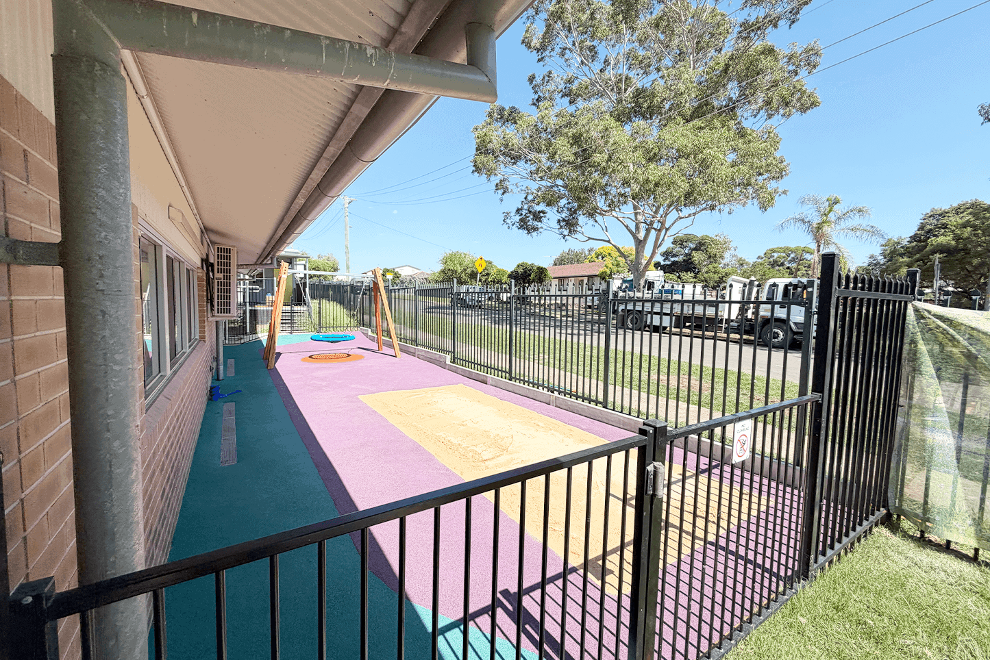 Colorful playground with safety surfacing and fencing by Said Civil Contractors.