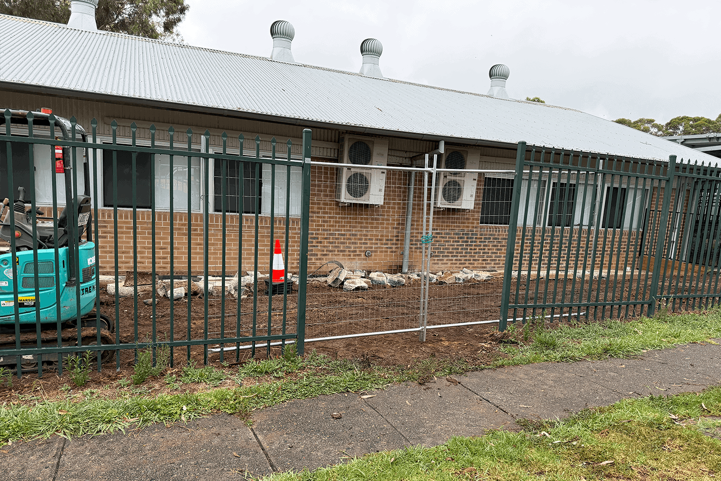 Construction fencing installed around a building by Said Civil Contractors.