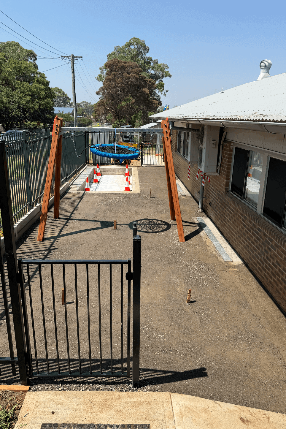New playground swing set installation by Said Civil Contractors in progress.