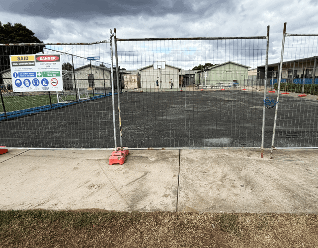 Secure construction site fencing with safety signs and environmental focus.